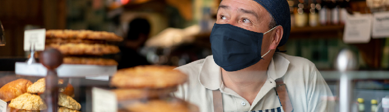 web banner showing business owner wearing a mask