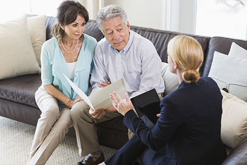 senior couple talking with financial advisor