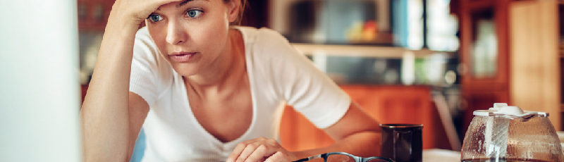 woman stressfully looking at her laptop