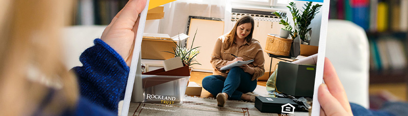 Person holding a physical copy of the homebuyer playbook