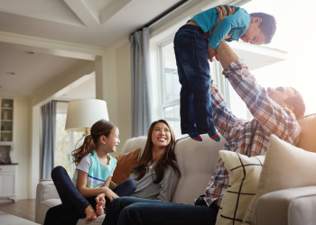 Happy family on a couch inside their home